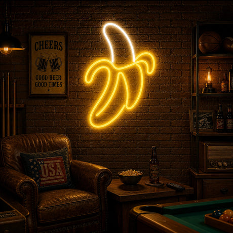 Banana Man Cave Neon Sign lighting up a game room wall above a snack counter at night