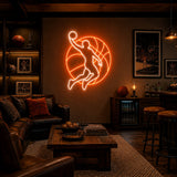 Basketball Player Man Cave Neon Sign lighting up a basketball room wall above a sofa at night