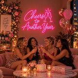 Pink Cheers to Another Year neon sign at a celebration
