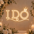 I Do neon sign with ring and heart accents glowing in warm white