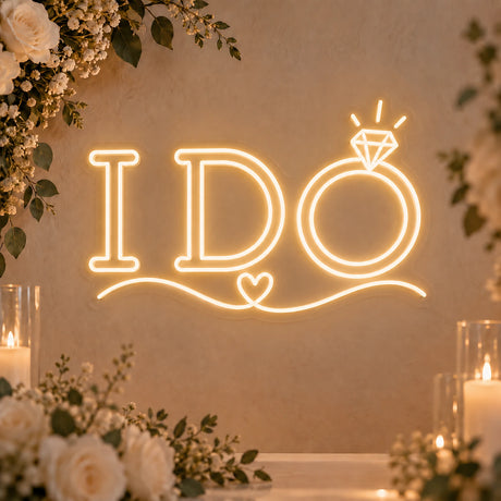 I Do neon sign with ring and heart accents glowing in warm white