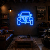 Off-Road 4x4 Man Cave Neon Sign lighting up a workshop wall facing the garage door at night