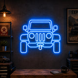 Off-Road 4x4 Man Cave Neon Sign glowing on a workshop wall facing the garage door