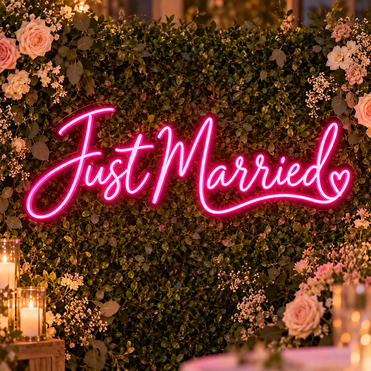 Pink Just Married neon sign on a flower wall wedding backdrop