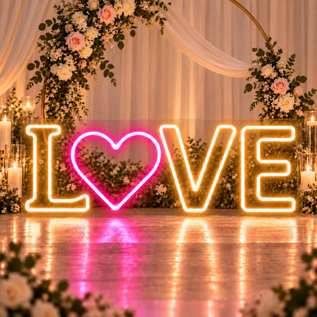 White LOVE neon sign with pink heart glowing in warm white