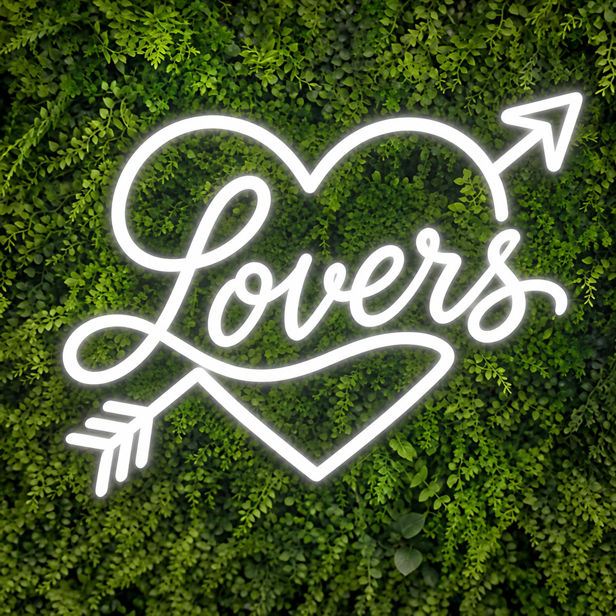 White Lovers neon sign with heart and arrow on a green wall