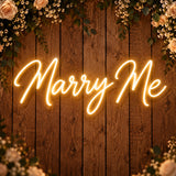 Marry Me neon sign on a wooden wall for a wedding proposal