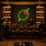 Green Olive Cocktail LED Neon Sign displayed in a martini bar setting