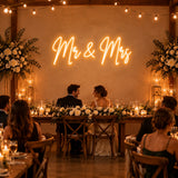 Mr & Mrs neon sign behind a wedding reception head table