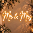 Mr & Mrs wedding neon sign in warm white on a wall