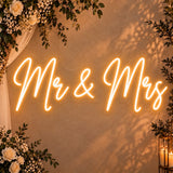 Mr & Mrs wedding neon sign in warm white on a wall