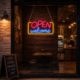 Welcome open LED neon sign mounted at a salon reception desk