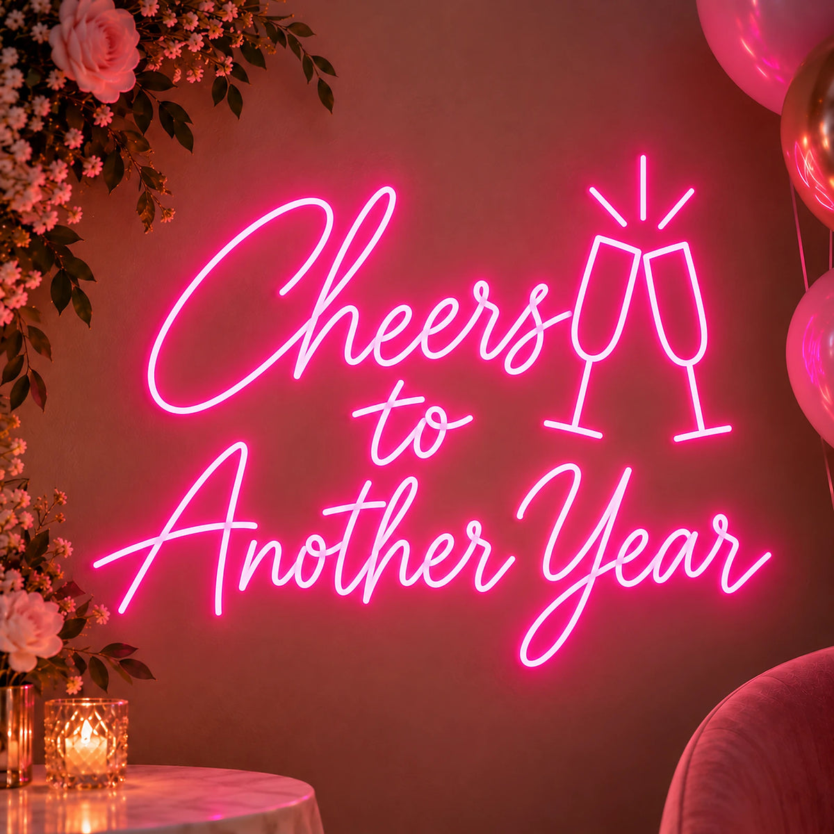 Pink Cheers to Another Year neon sign on a party wall