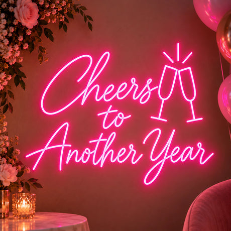 Pink Cheers to Another Year neon sign on a party wall
