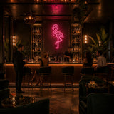 Pink Flamingo LED Neon Sign displayed in a tiki bar setting