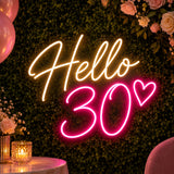 Pink Hello 30 neon sign on a green flower wall