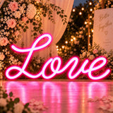 Pink cursive Love neon sign as wedding reception décor