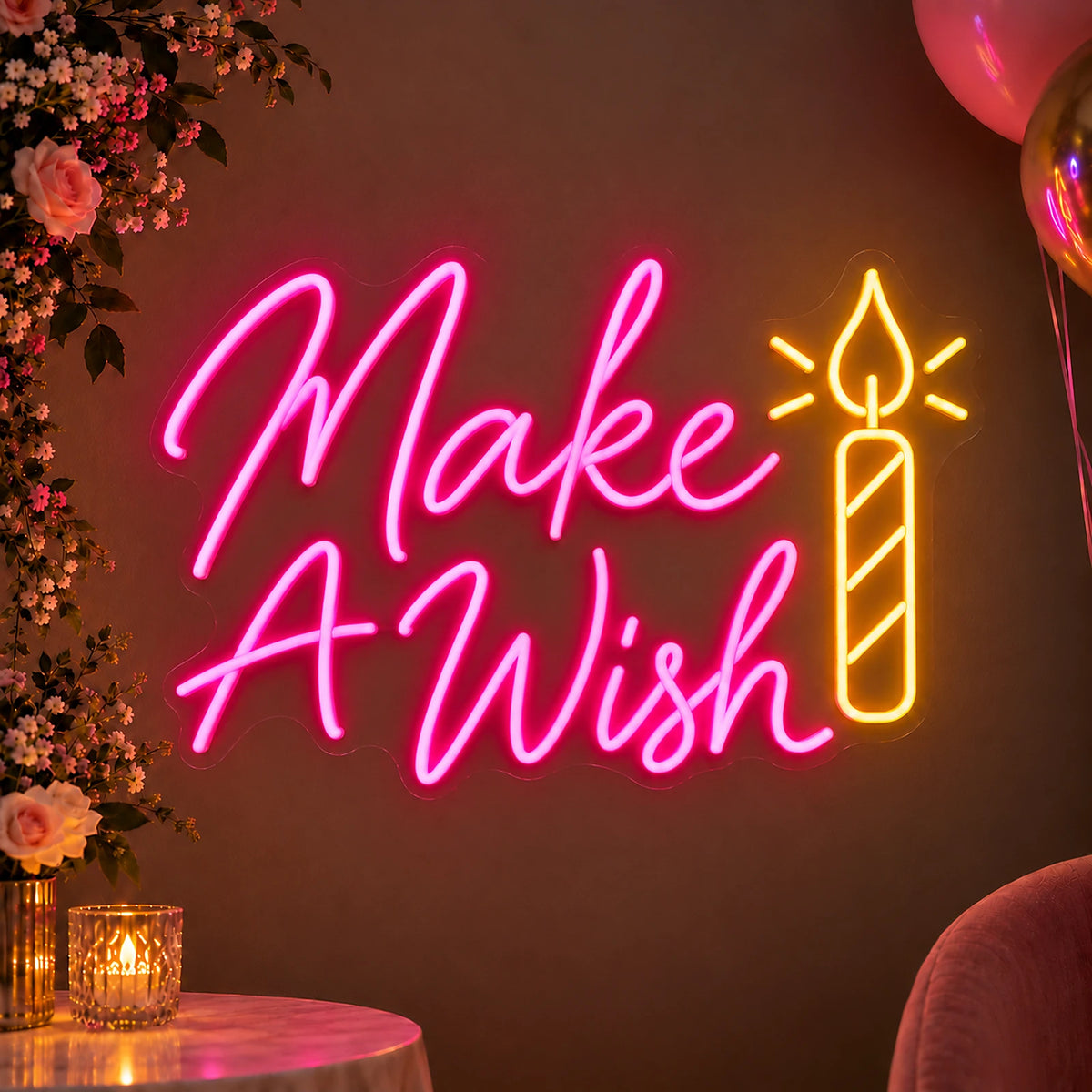 Pink Make A Wish neon sign with candle at a party