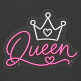 Pink Queen crown neon sign lit on a dark gray background
