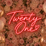 Red Twenty One neon sign on a 21st birthday flower wall