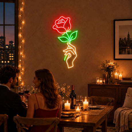 Hand holding rose neon sign at a romantic dinner