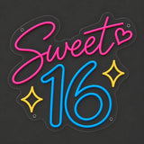 Pink and blue Sweet 16 neon sign lit on a dark gray background