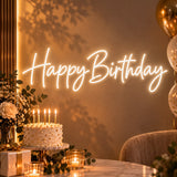 Warm white Happy Birthday neon sign behind a cake display