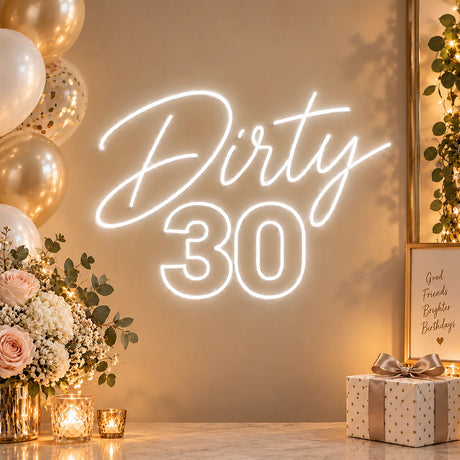 White Dirty 30 neon sign with gold birthday décor
